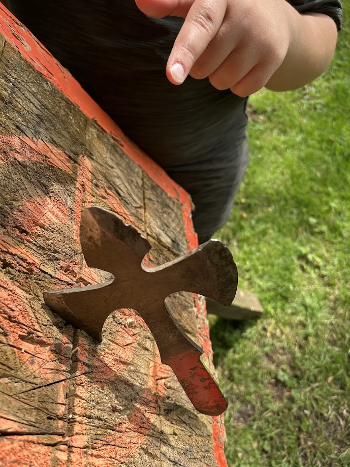 A smiling participant on the tomahawk range at Wood-Sage Outdoor after a successful throw.