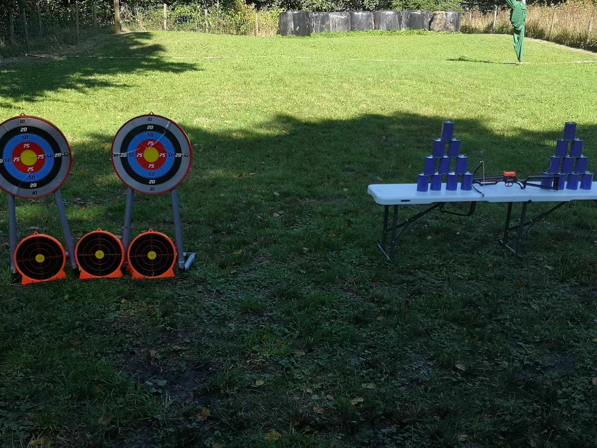 Soft crossbow targets during a supervised kids' activity session, with sucker darts.