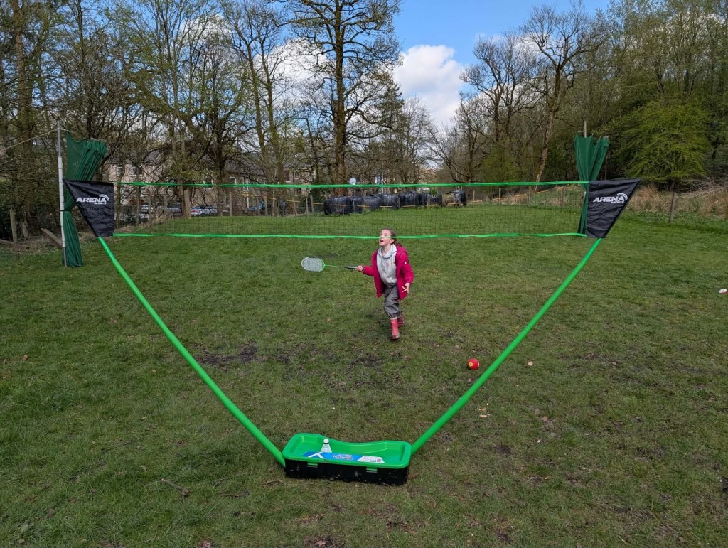 Child playing badminton outdoors during Easter HAF 2026 at Wood‑Sage Outdoor Education.