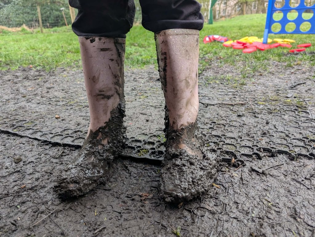 Muddy children’s boots after outdoor play during Easter HAF 2026 at Wood‑Sage Outdoor Education