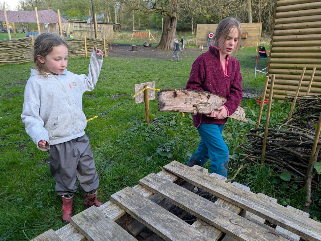 Children adding wood and natural materials to a bug hotel during Easter HAF 2026 at Wood‑Sage Outdoor Education