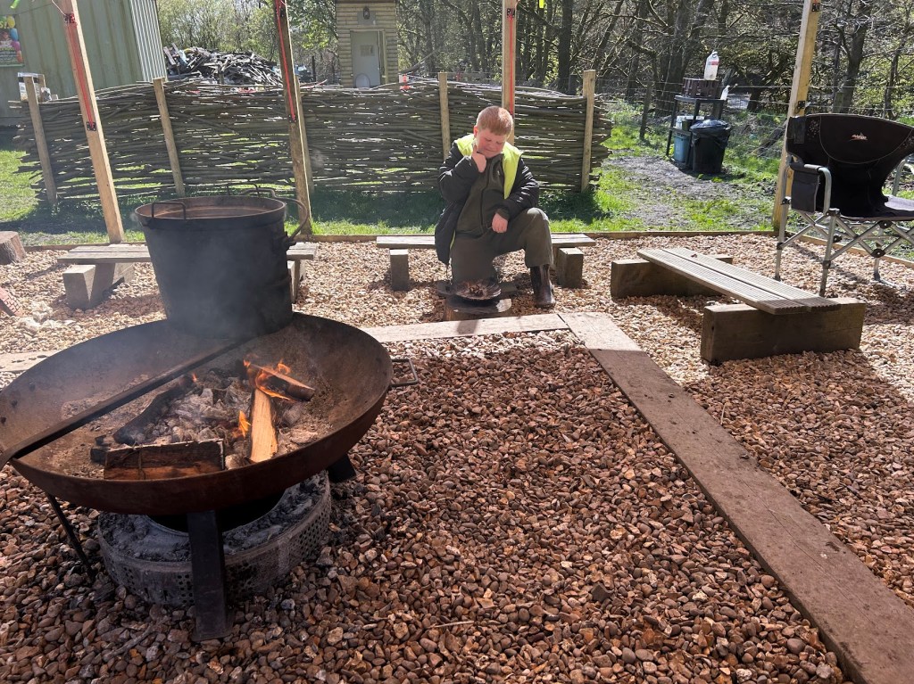 Campfire burning after being successfully lit from a spark during Easter HAF 2026 at Wood‑Sage Outdoor Education.
